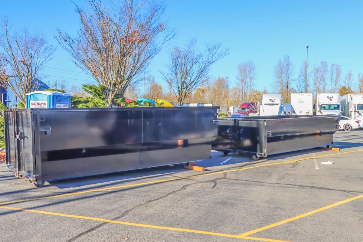 Professional dumpster rental service with roll-off container on residential driveway in Lorain